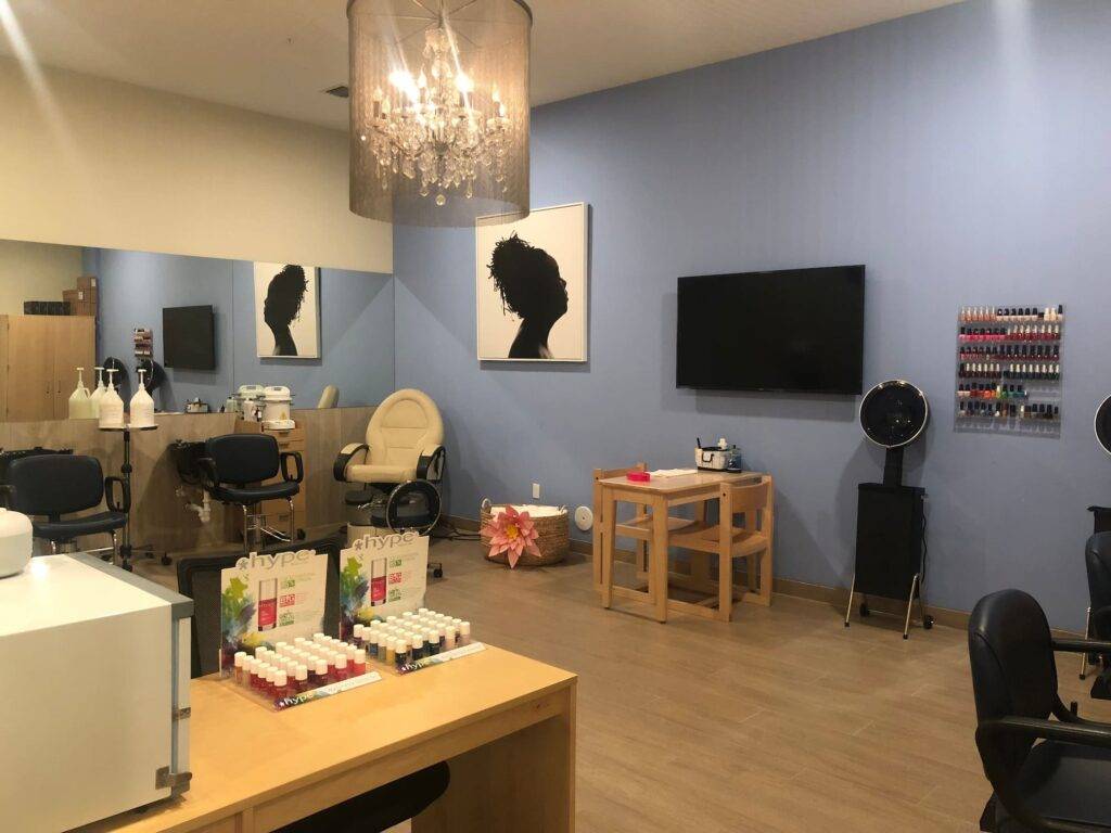 Modern beauty salon interior with stylish decor, nail polish rack, and hair styling stations.