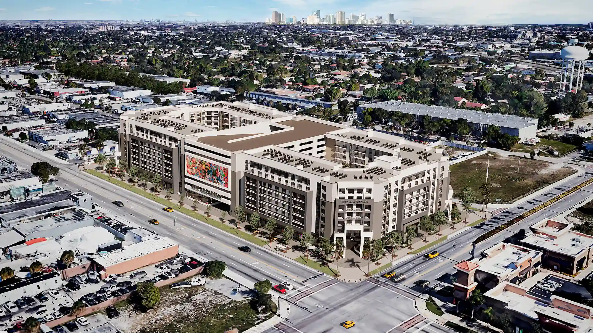 Aerial view of a modern urban development surrounded by roads and buildings in a bustling cityscape.