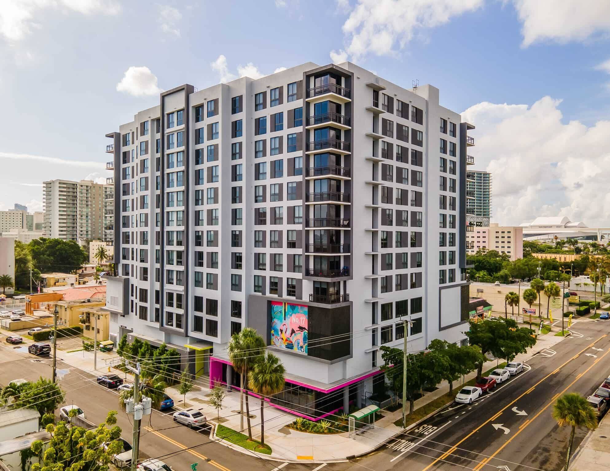 Modern city apartment building with vibrant street view and urban surroundings.