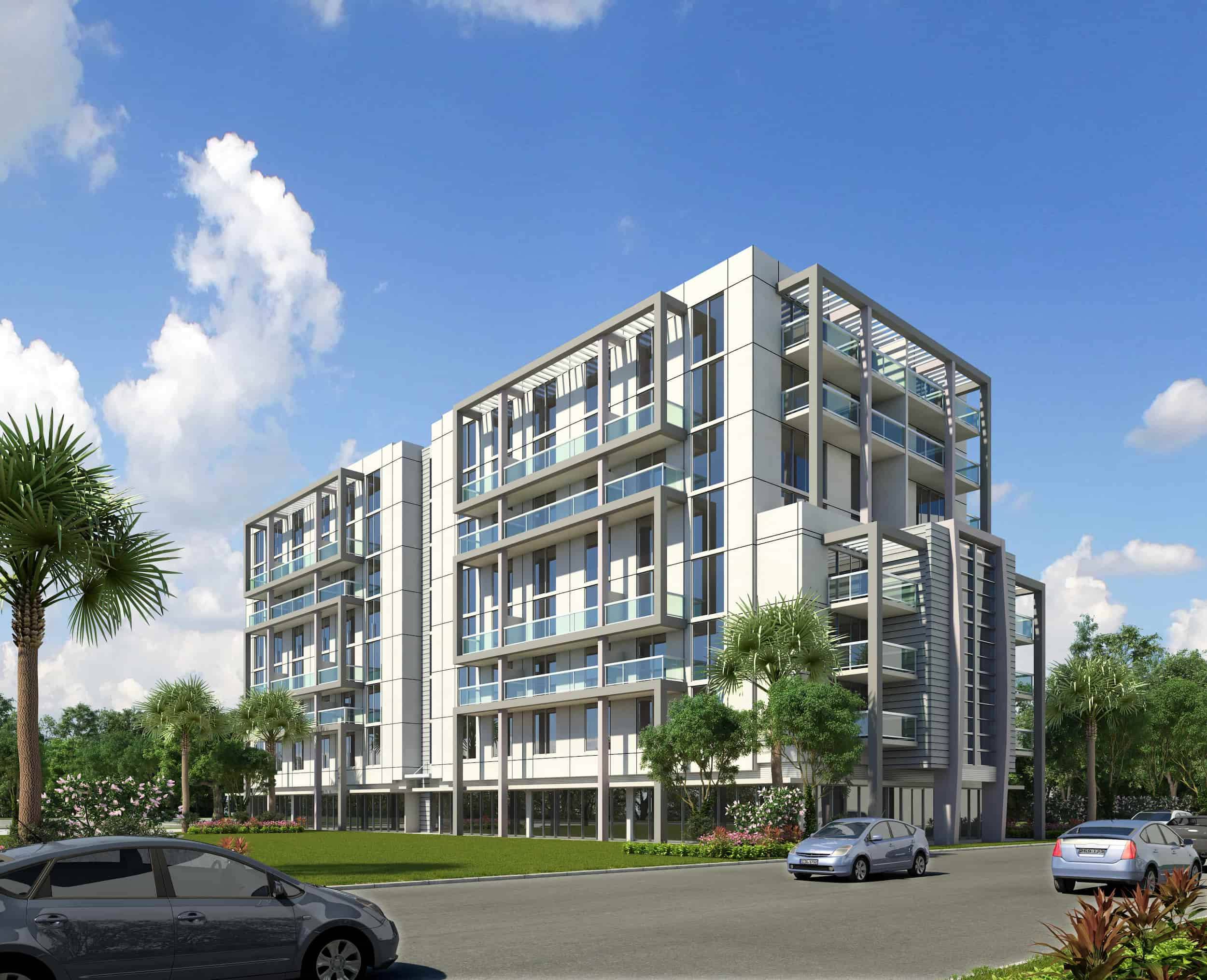 Modern multi-story building with glass balconies and surrounding palm trees under a clear blue sky.