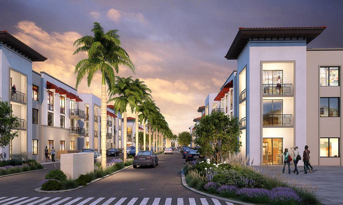 Modern apartment complex with palm trees lining a vibrant street at sunset.