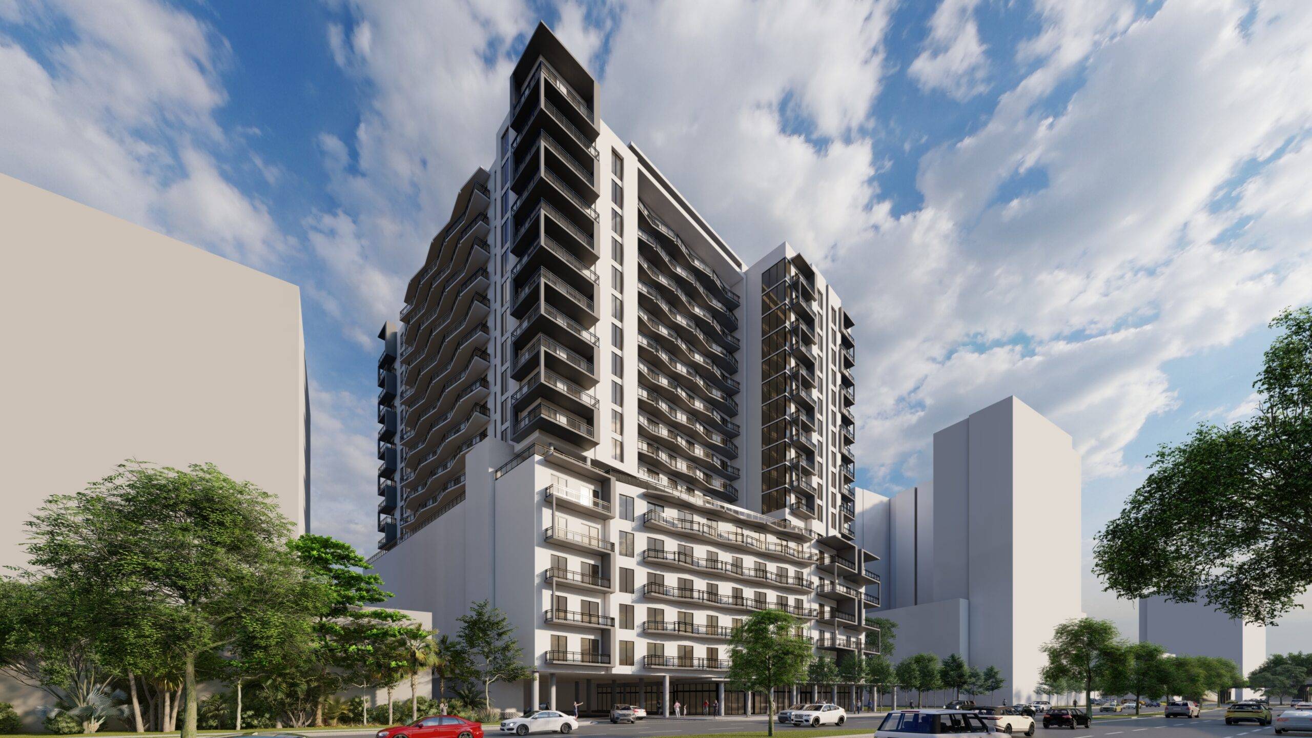 Modern high-rise building against a dynamic cloudy sky, surrounded by urban architecture.