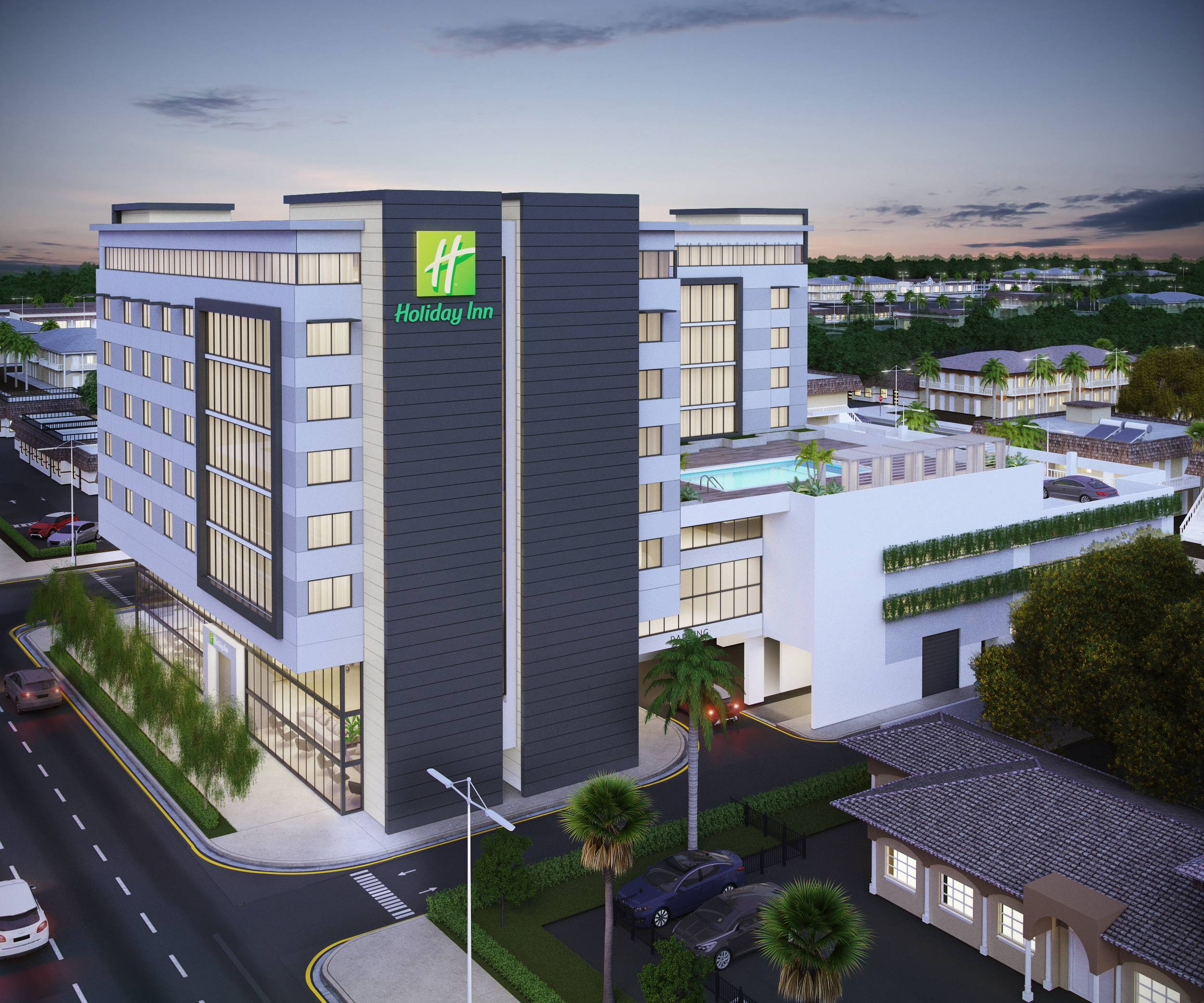 Modern hotel exterior with sleek design and city view at dusk.