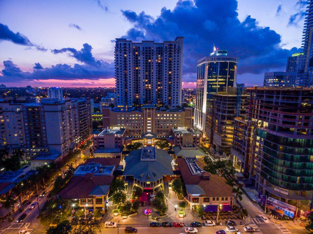 Vibrant city skyline at sunset with tall buildings and colorful lights creating a mesmerizing urban landscape.
