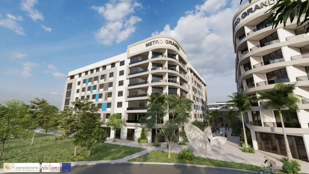 Modern architectural view of Metro Grande with lush greenery and clear blue skies.