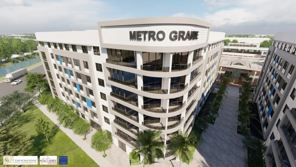 Aerial view of Metro Grande building with modern architecture and lush surroundings.