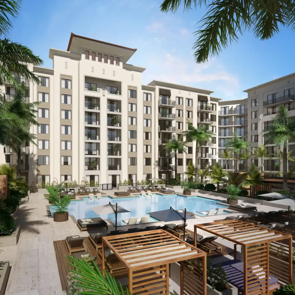 Luxurious apartment complex with a central swimming pool and lush palm trees.