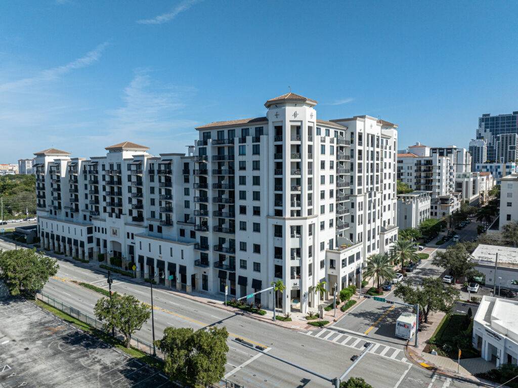 Luxury residential building with modern architectural design under a clear blue sky.