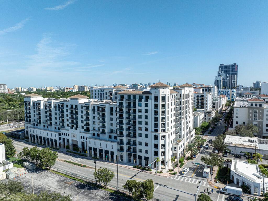 Merrick Manor luxury apartment complex amidst a vibrant urban landscape.
