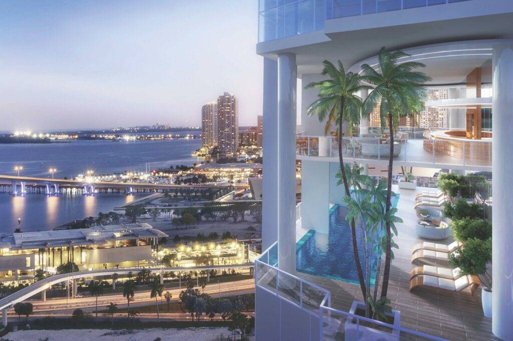 Luxury high-rise overlooking Miami waterfront with indoor palm trees.