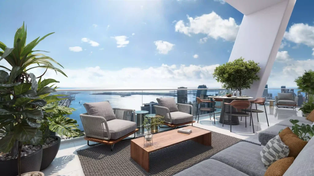 Luxurious terrace with modern furniture offering a stunning view of Miami's skyline and ocean.