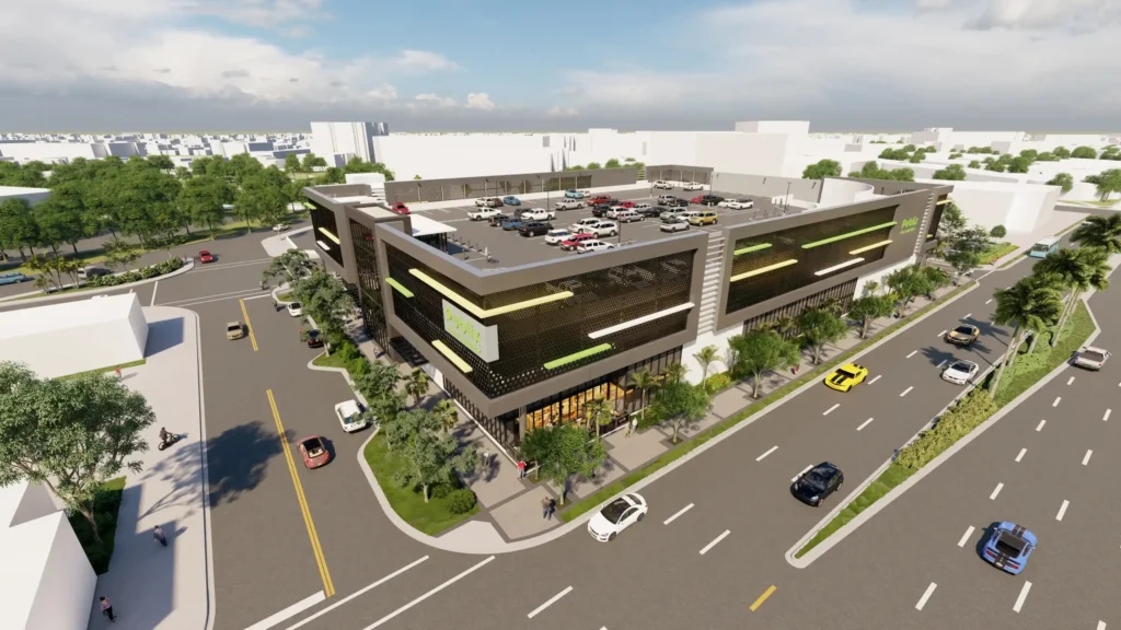 Aerial view of a modern two-level commercial building with a rooftop parking area, surrounded by busy streets and green landscaping.