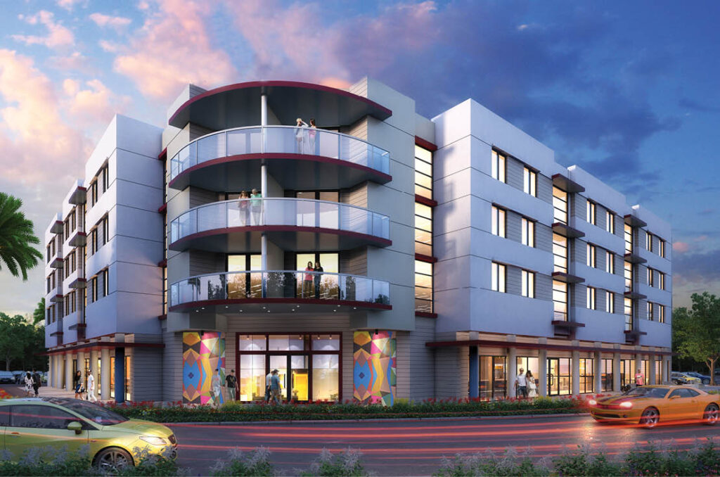 Modern urban building with colorful murals under a dramatic sunset sky.