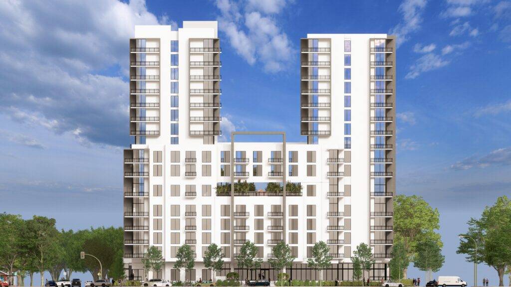 Modern high-rise building with lush greenery and blue sky background.