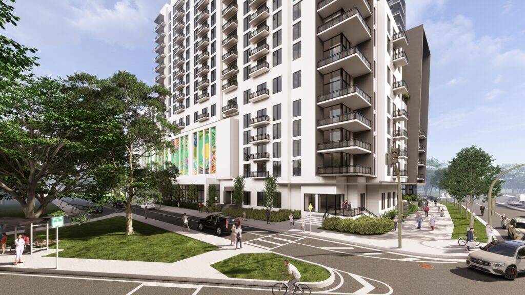 Modern high-rise apartment building with green spaces and street view in urban setting.