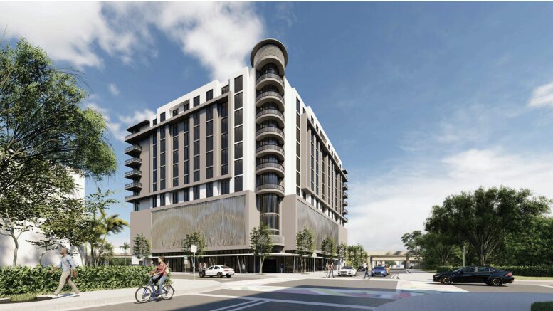 Modern multi-story building with contemporary architectural design surrounded by trees and cyclists.