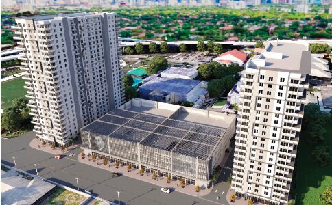 Aerial view of modern high-rise buildings surrounded by greenery and urban landscape.
