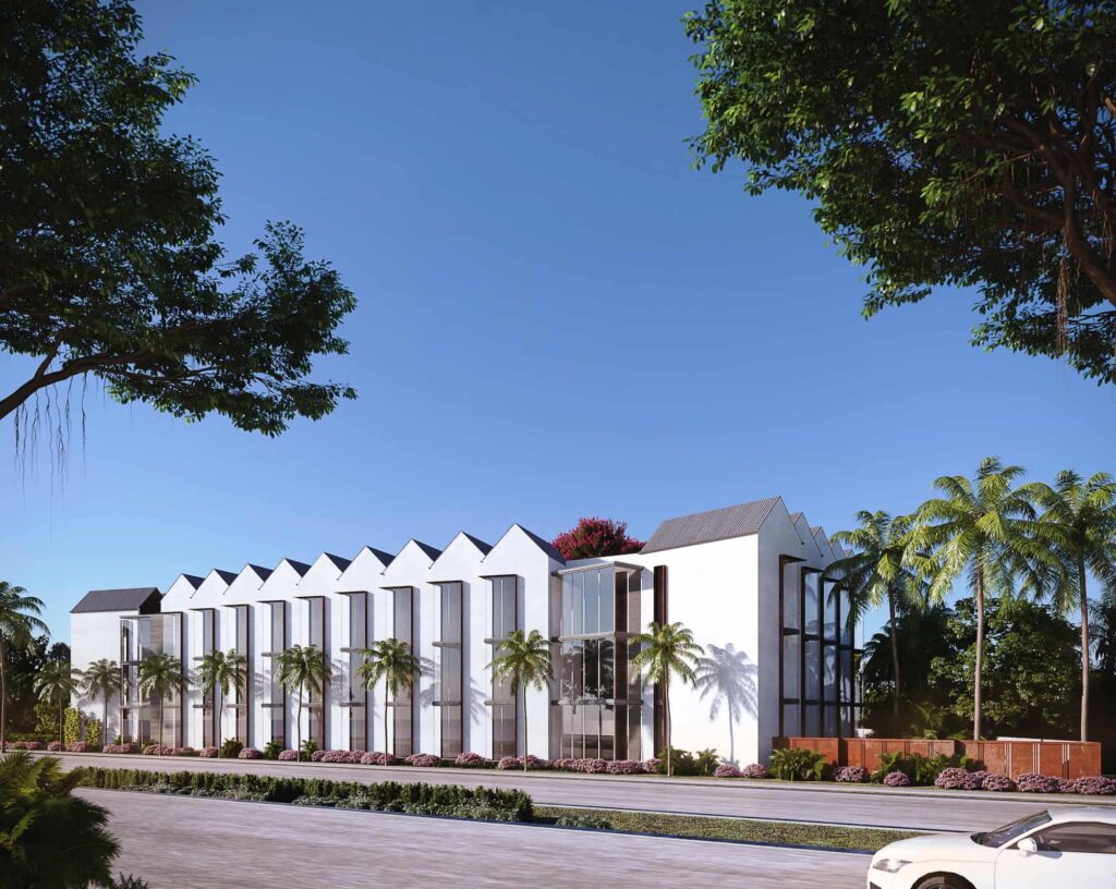 Modern white building with triangular roof design surrounded by palm trees under a clear blue sky.