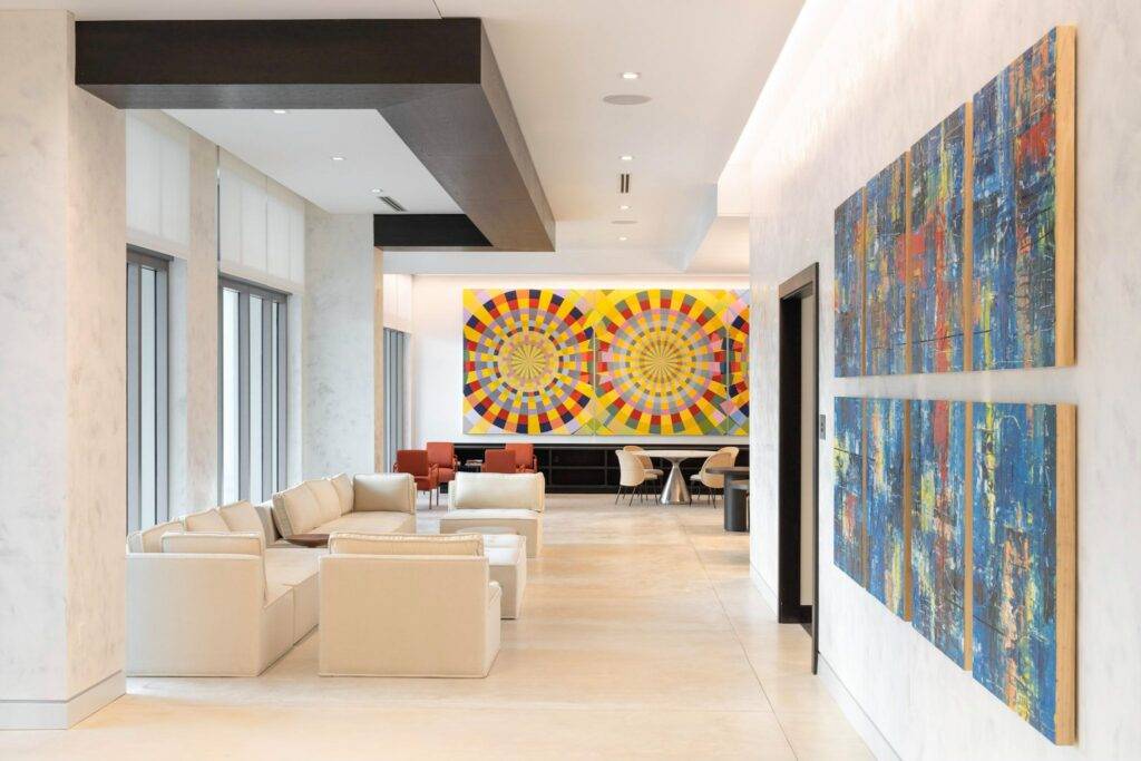 Modern lounge with abstract artwork and cozy seating.
