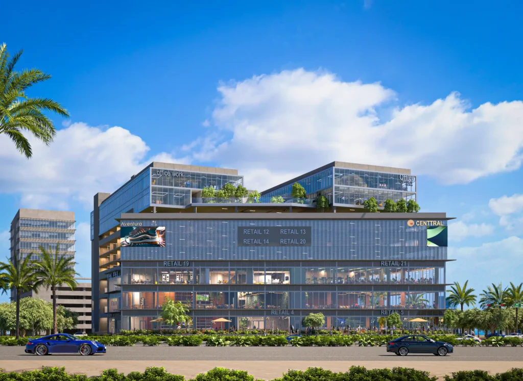 Modern commercial building with glass facade and lush rooftop gardens under a bright blue sky.