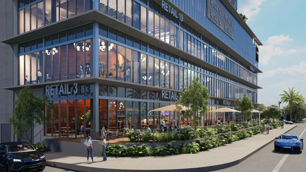 Modern urban building with glass facade and outdoor seating, vibrant street view.