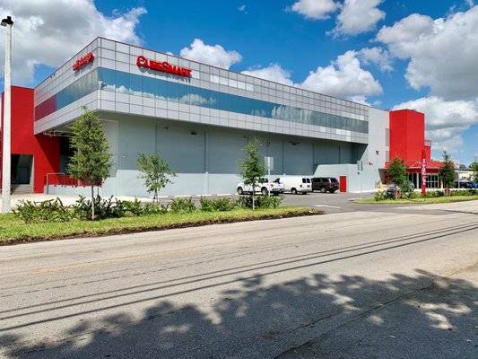 Modern storage facility with sleek architecture under a bright blue sky.