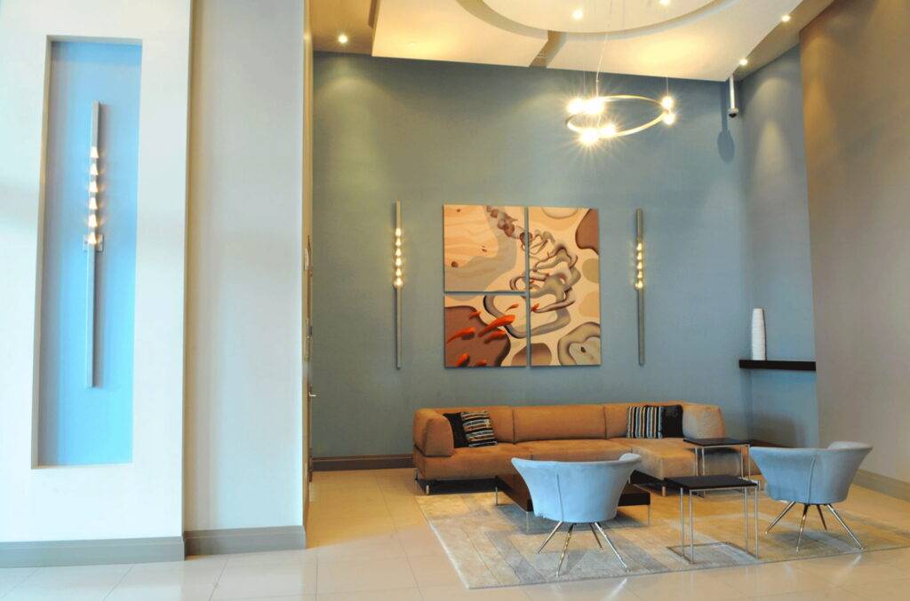 Modern lobby with abstract art and sleek furniture.