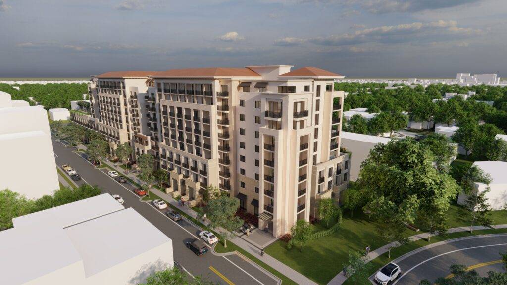 Aerial view of a modern apartment building surrounded by greenery and urban landscape.