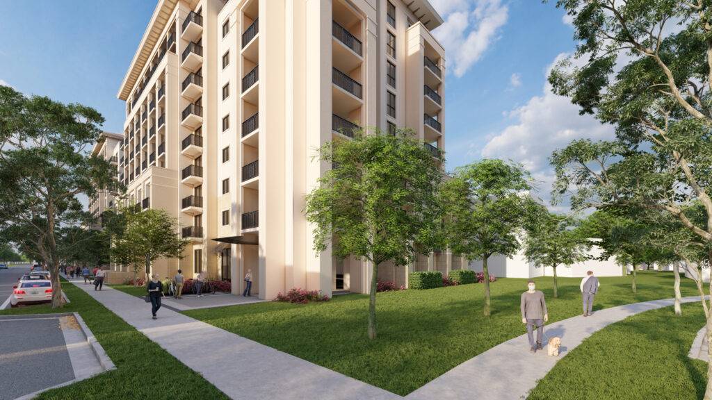 Modern apartment building with lush green surroundings and a clear blue sky.