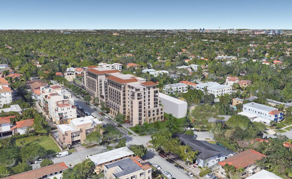 Aerial view of a residential neighborhood with a large contemporary building amid lush green surroundings.