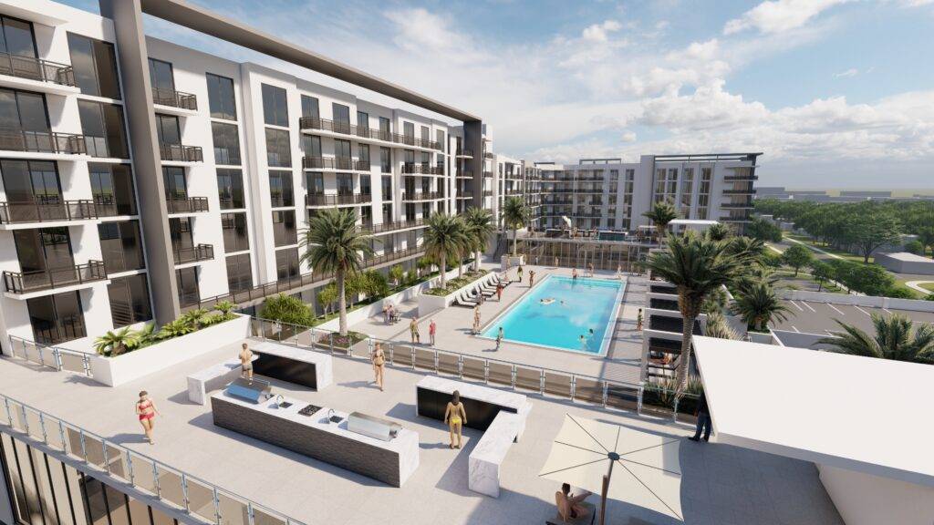 Modern apartment complex with pool and palm trees under a blue sky.