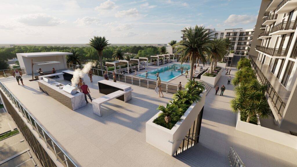 Rooftop view of a luxury apartment complex with a pool, palm trees, and people relaxing.