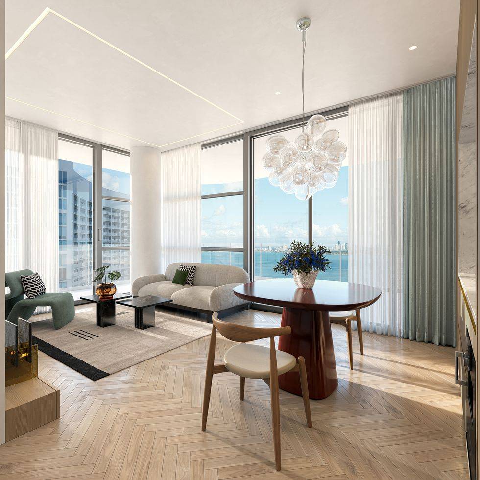 Luxurious Miami living room with ocean view, modern decor, and elegant chandelier.