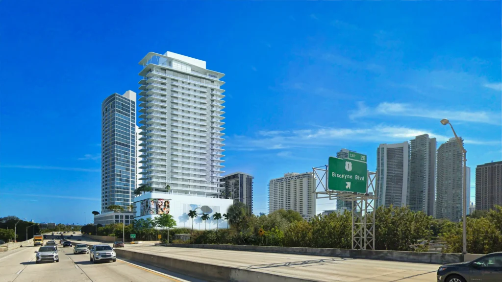 Modern skyscrapers and highway with clear blue sky backdrop.