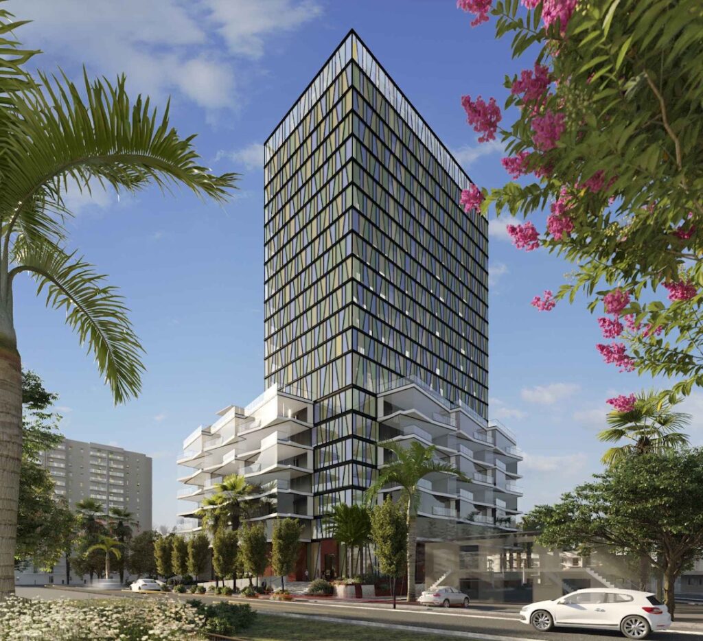 Modern high-rise building with glass facade surrounded by palm trees and vibrant flowers.