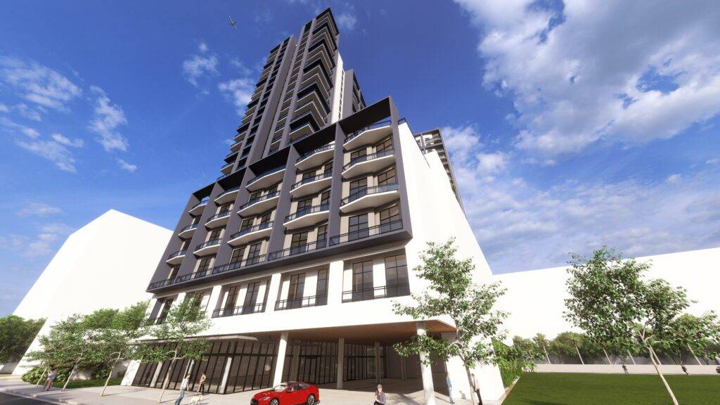 Modern multi-story building with glass balconies and a vibrant red car parked in front under a blue sky.