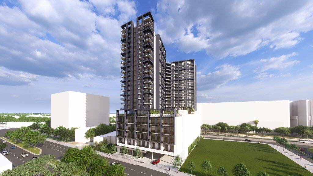 Modern high-rise apartment building under a partly cloudy sky with surrounding greenery.