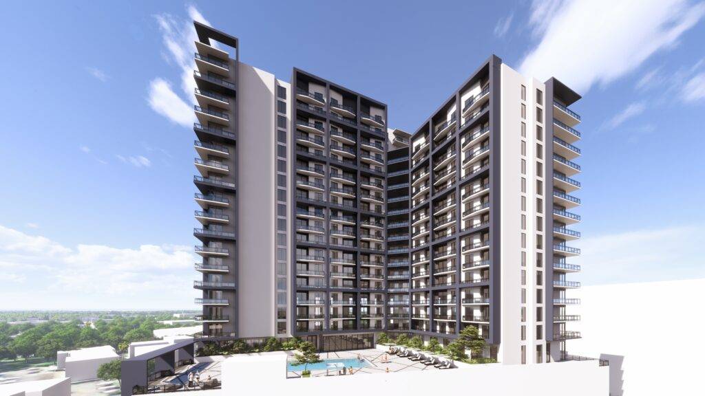 Modern high-rise residential building with balconies and a swimming pool under a clear blue sky.