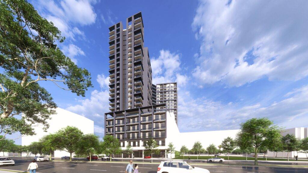 Modern high-rise building against a bright blue sky with white clouds.