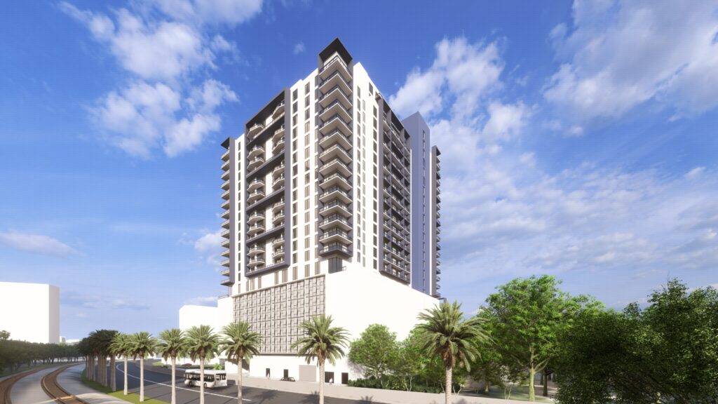 Modern high-rise with balconies under a clear blue sky.