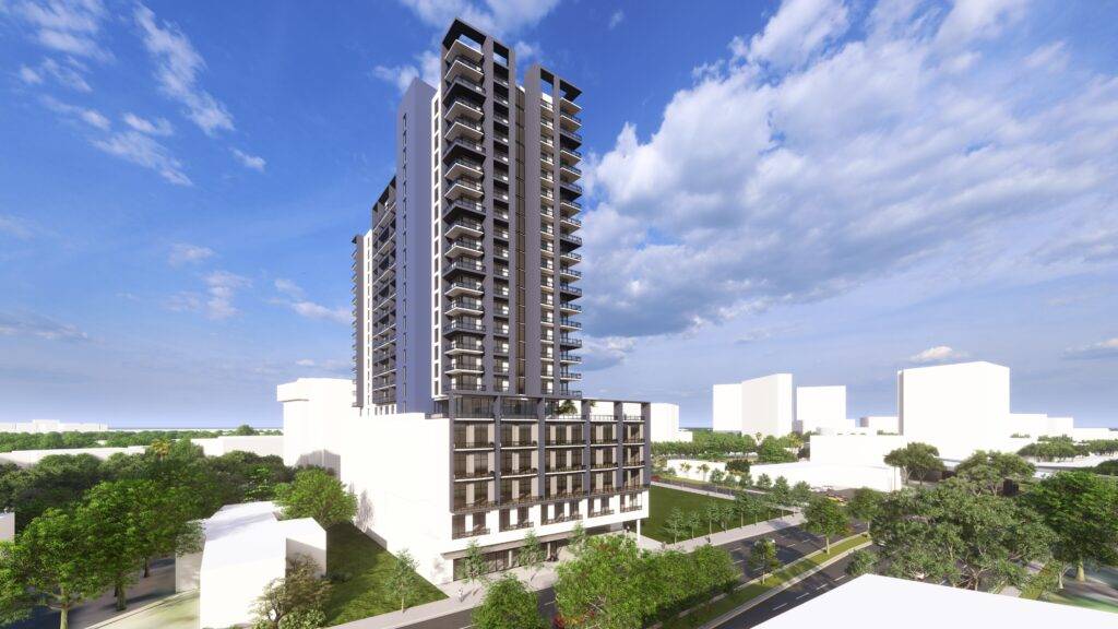 Modern high-rise building against a bright blue sky with white clouds, surrounded by greenery.