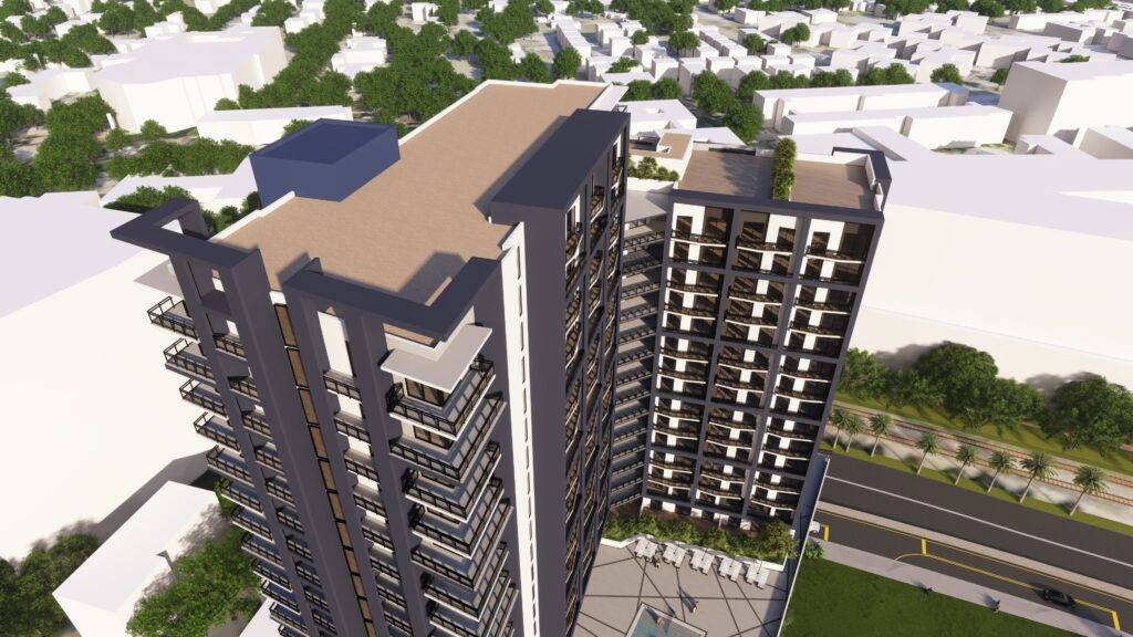 Aerial view of a modern high-rise building with a landscaped rooftop terrace, surrounded by a bustling urban area.