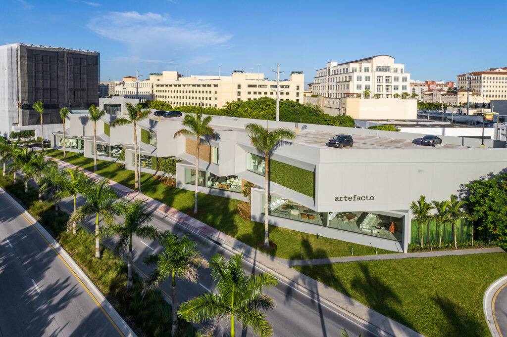 Aerial view of Artefacto Coral Gables showroom, showcasing modern architecture and lush greenery.
