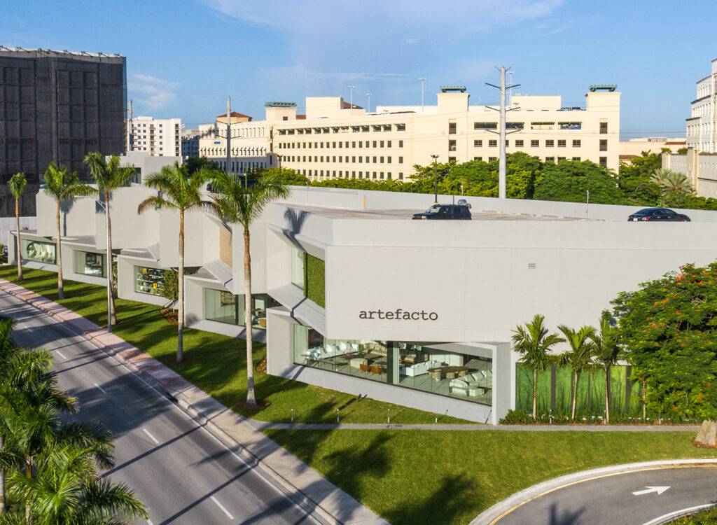 Aerial view of Artefacto Coral Gables showroom with modern architecture and lush greenery.