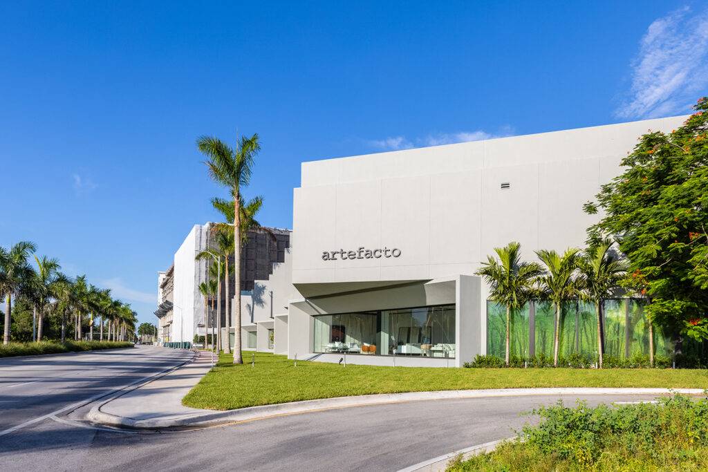 Modern white showroom with palm trees and clear blue sky in Coral Gables.