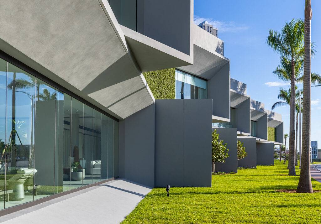 Modern architectural design of Artefacto Coral Gables showroom with sleek lines and green lawn.