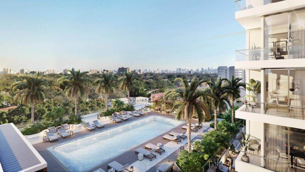 Luxurious rooftop pool with city skyline and lush greenery views.