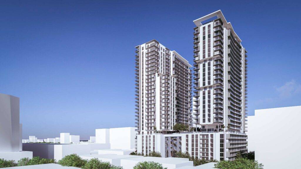 Modern high-rise buildings under a clear blue sky.