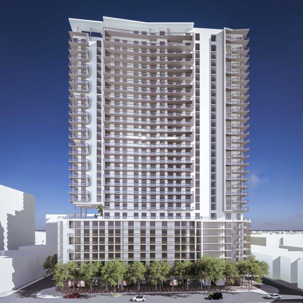Modern high-rise building with a sleek design and numerous balconies against a clear blue sky.