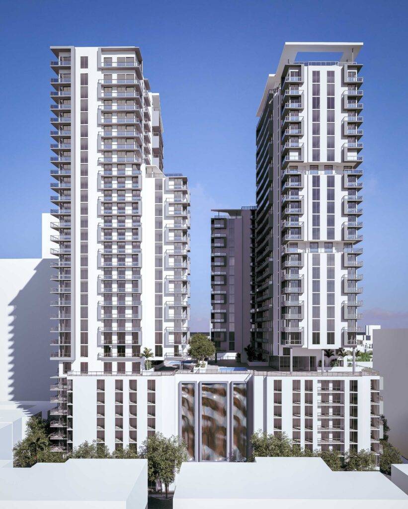 Modern high-rise buildings against a clear blue sky, showcasing sleek architectural design.